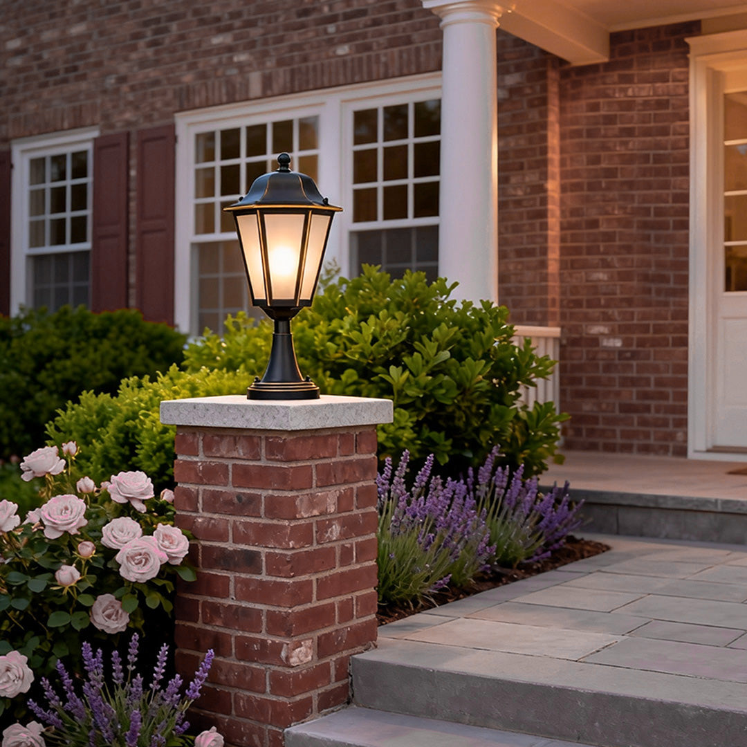 Elegant outdoor pillar light mounted on stone pillar, enhancing the entrance of a residential home with warm light.
