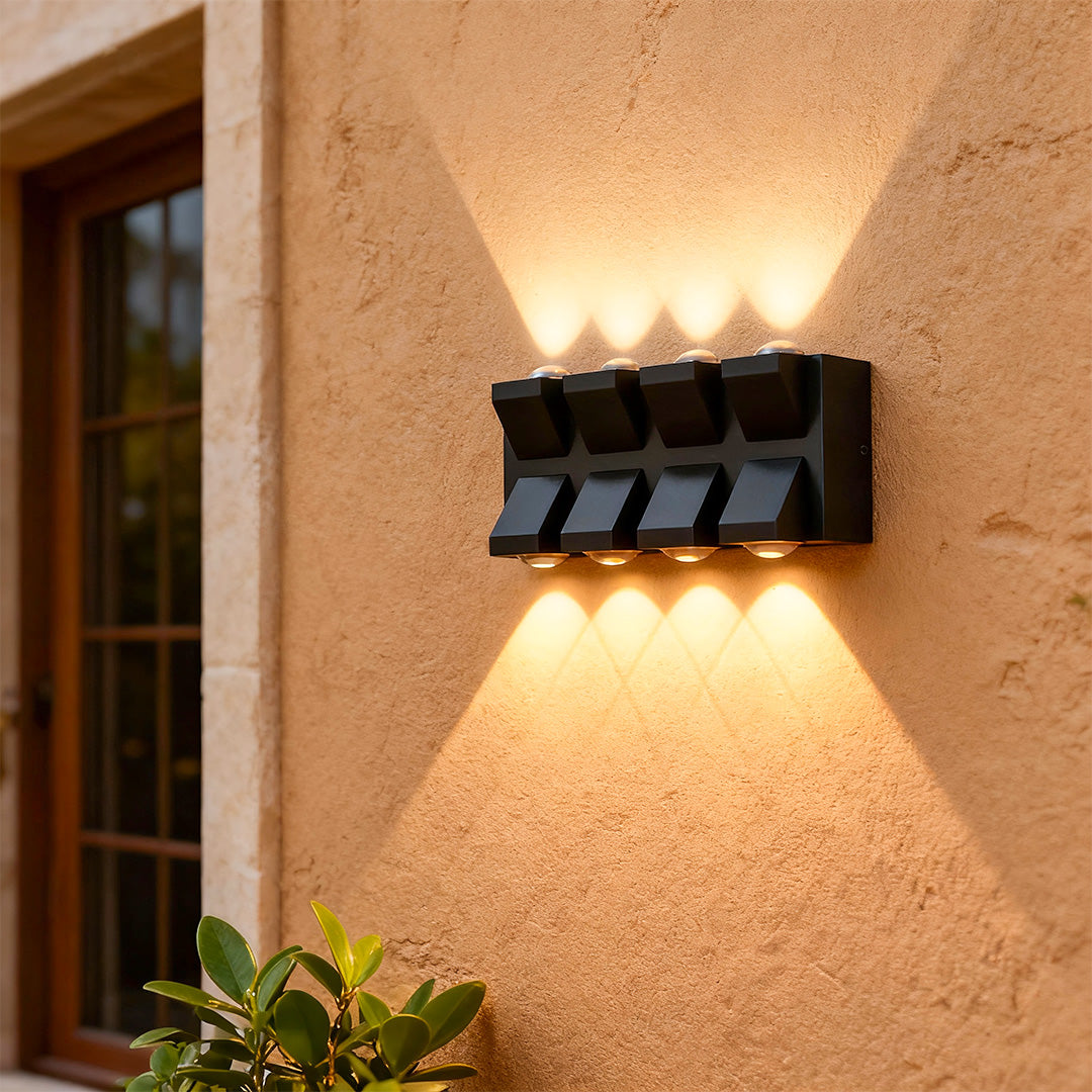 Elegant outdoor wall lights black with glass shade chandelier design illuminating warm-toned stucco exterior with bidirectional glow.