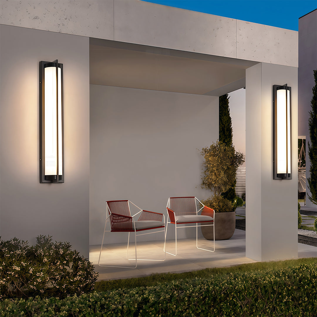 Elegant outdoor wall sconces black featuring glass shade chandelier styling providing warm ambient glow on white stucco patio wall.