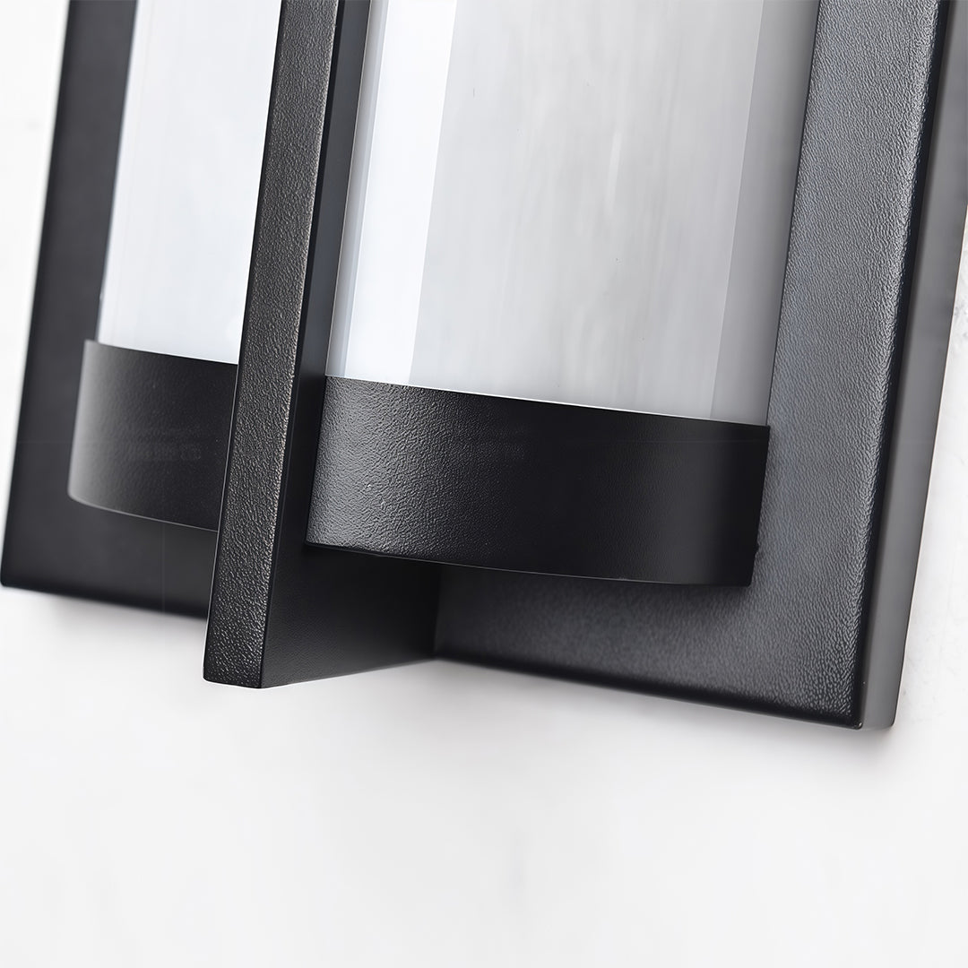 Elegant outdoor wall sconces black featuring glass shade chandelier styling providing warm ambient glow on white stucco patio wall.