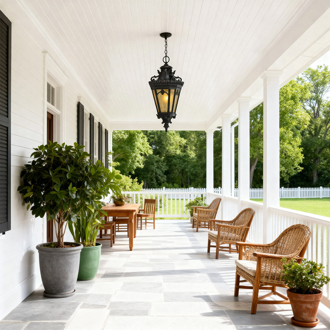 Elegant pendant light outdoor suspended in covered veranda with wicker furniture and potted plants