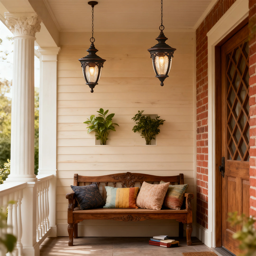 Elegant pendant porch lights suspended from white ceiling near swing and decorative pillows