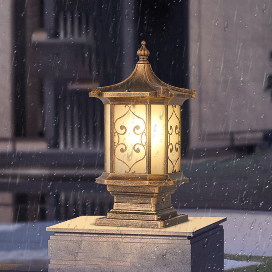 Elegant pillar light with ornate metalwork creating beautiful ambient lighting in evening setting