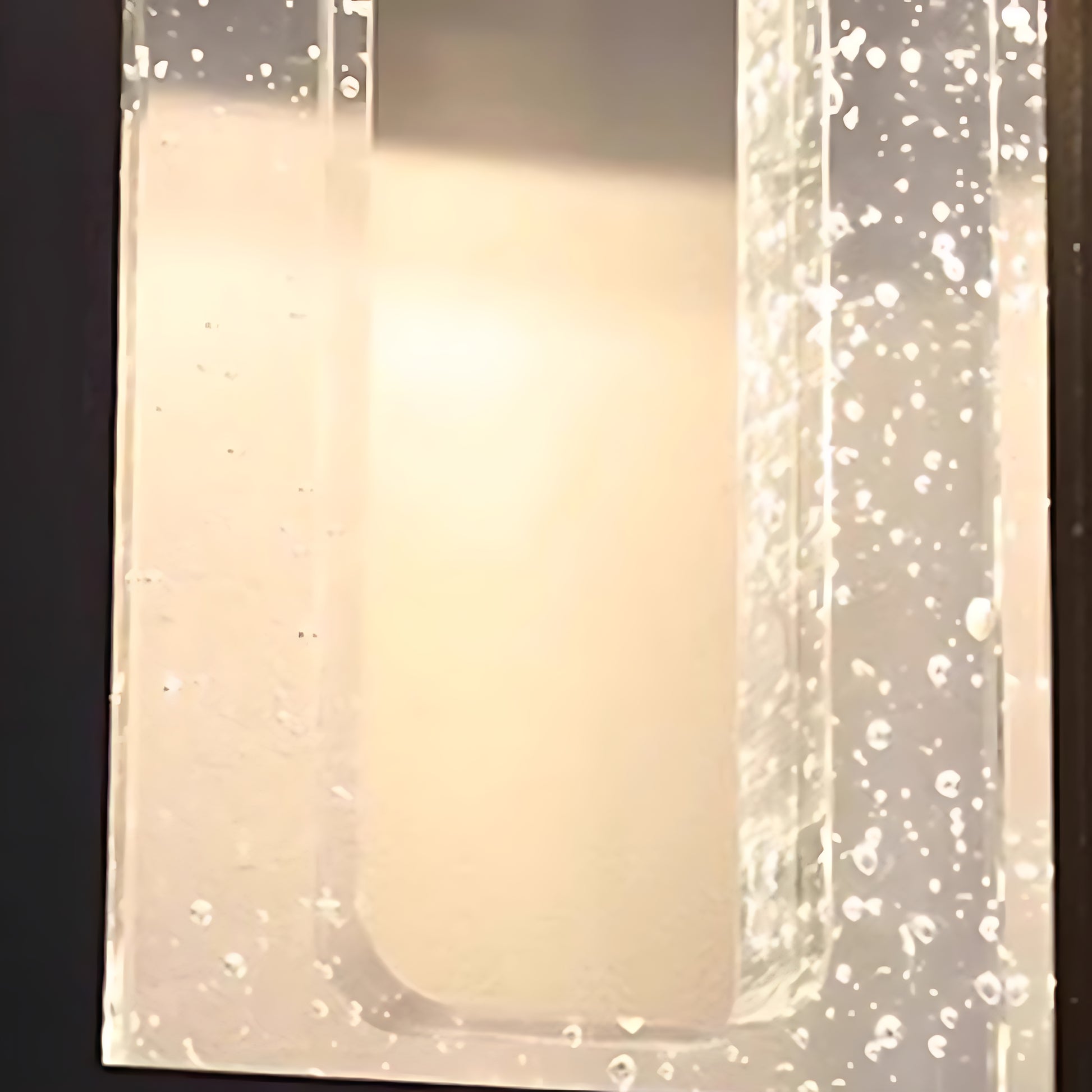 Elegant outdoor wall light with prismatic glass creating sparkled light pattern