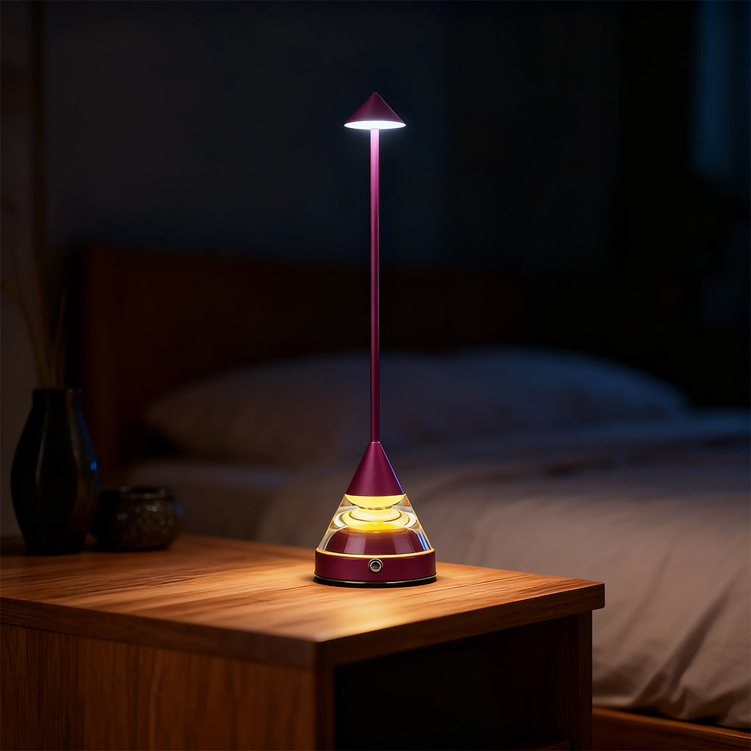 Elegant purple unique small table lamp providing soft bedside lighting in a dark bedroom setting.