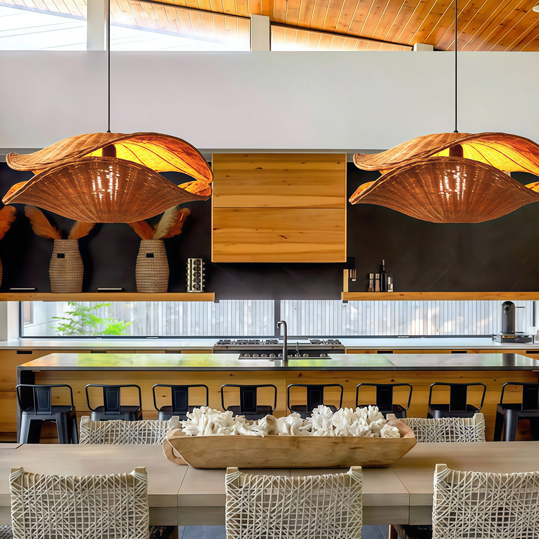 Elegant rattan pendant light illuminating a modern kitchen, combining rustic and contemporary design elements.