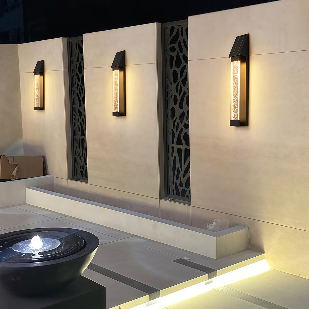 Black outdoor lighting sconce with a rectangular design, providing elegant illumination for outdoor spaces.