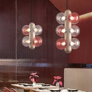 Elegant restaurant lighting with cluster pendant fixtures creating warm ambient dining atmosphere