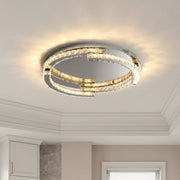 Elegant silver flush mount ceiling light with interlocking crystal rings and warm glowing LEDs.