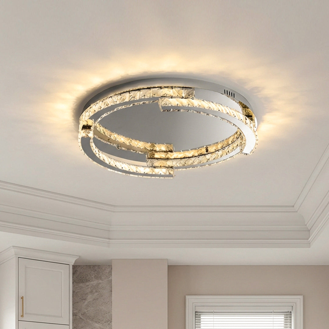 Elegant silver flush mount ceiling light with interlocking crystal rings and warm glowing LEDs.