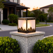 Elegant solar powered pillar lights on a stone pillar, providing warm illumination for a garden entrance.