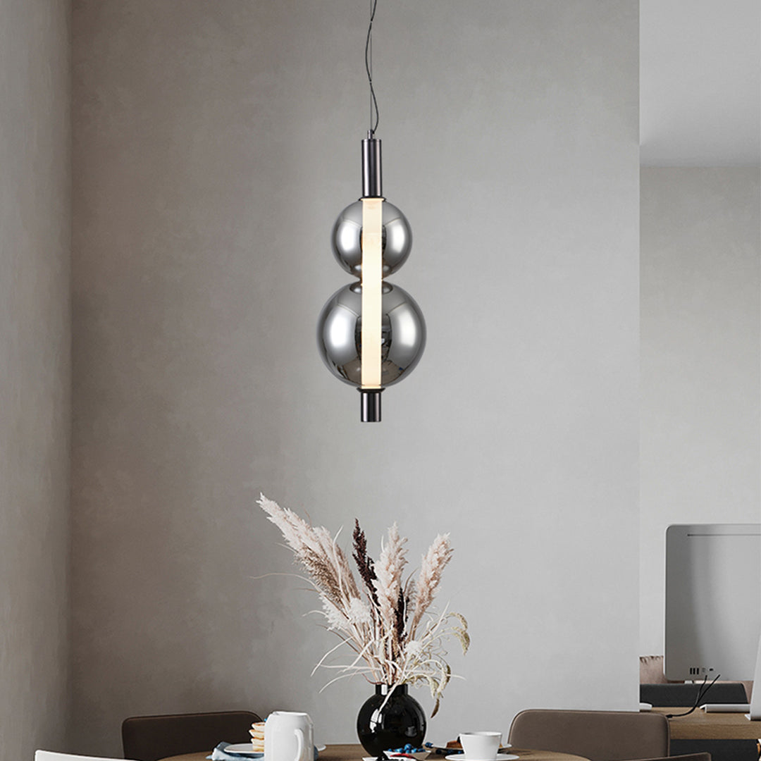 Elegant modern silver pendant light with transparent spherical bulb cover and black ceiling fixture
