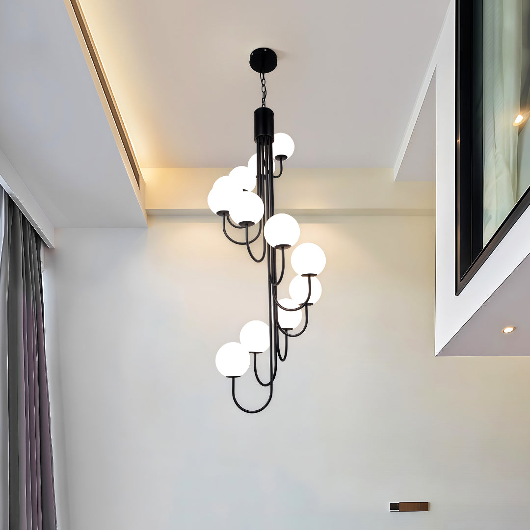 Elegant spiral globe chandelier in gold finish illuminating a stylish dining or sitting area.