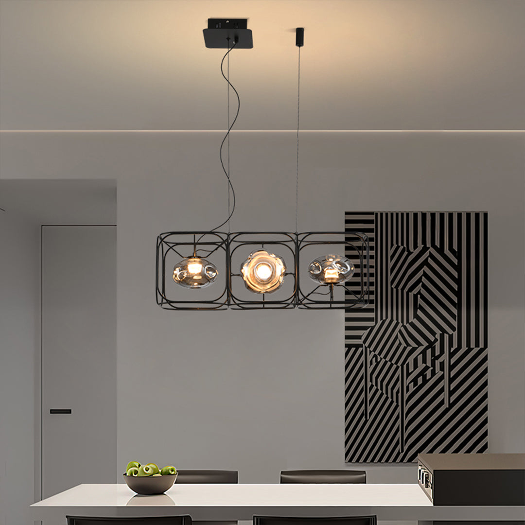 Elegant square cage chandelier positioned over minimalist dining area creating focused task lighting
