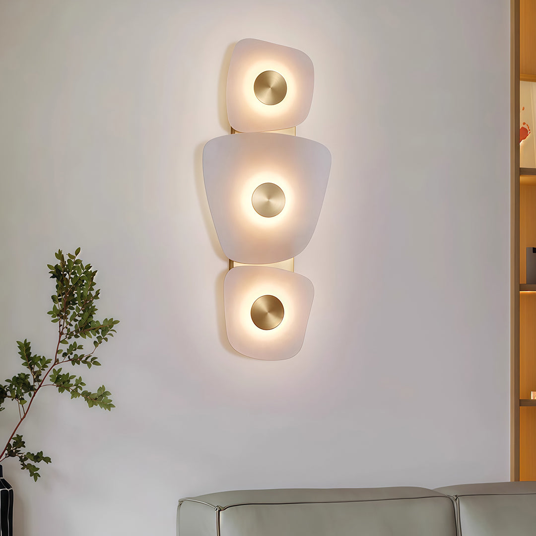Elegant wall art lighted featuring glass shade chandelier design creating ambient lighting in minimalist white interior with console.