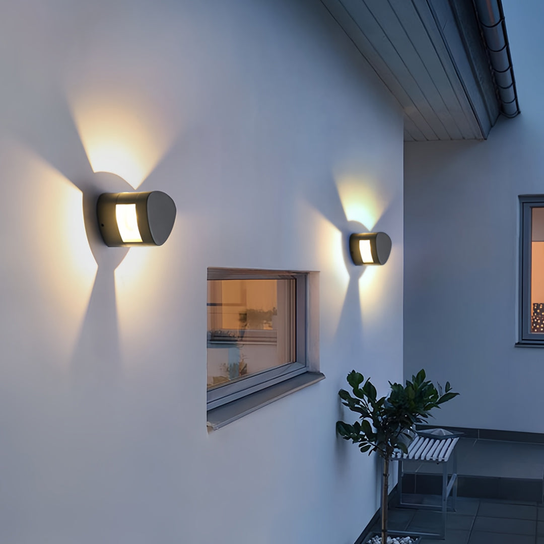 Elegant wall light outdoor fixtures providing ambient illumination along a minimalist exterior corridor.