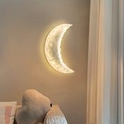 Elegant wall light moon creating soft nighttime ambiance in minimalist bedroom setting