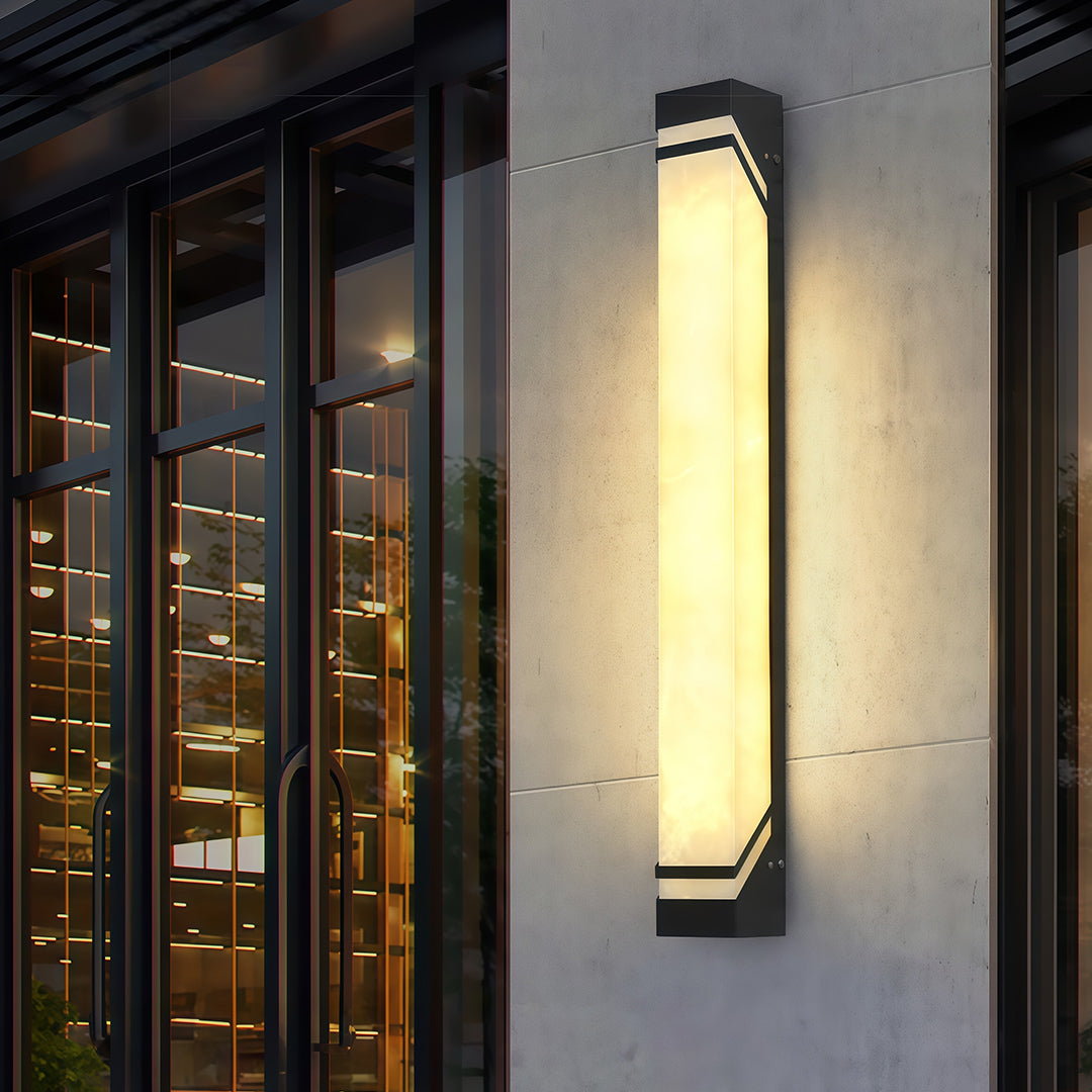 Elegant wall mounted exterior lights featuring glass shade chandelier styling illuminating modern entrance with warm ambient glow.