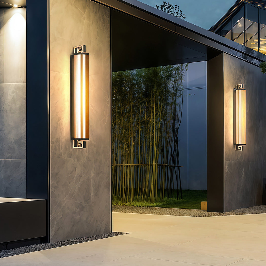 Elegant wall mounted linear lighting featuring glass shade chandelier design in tall vertical configuration with warm white glow.