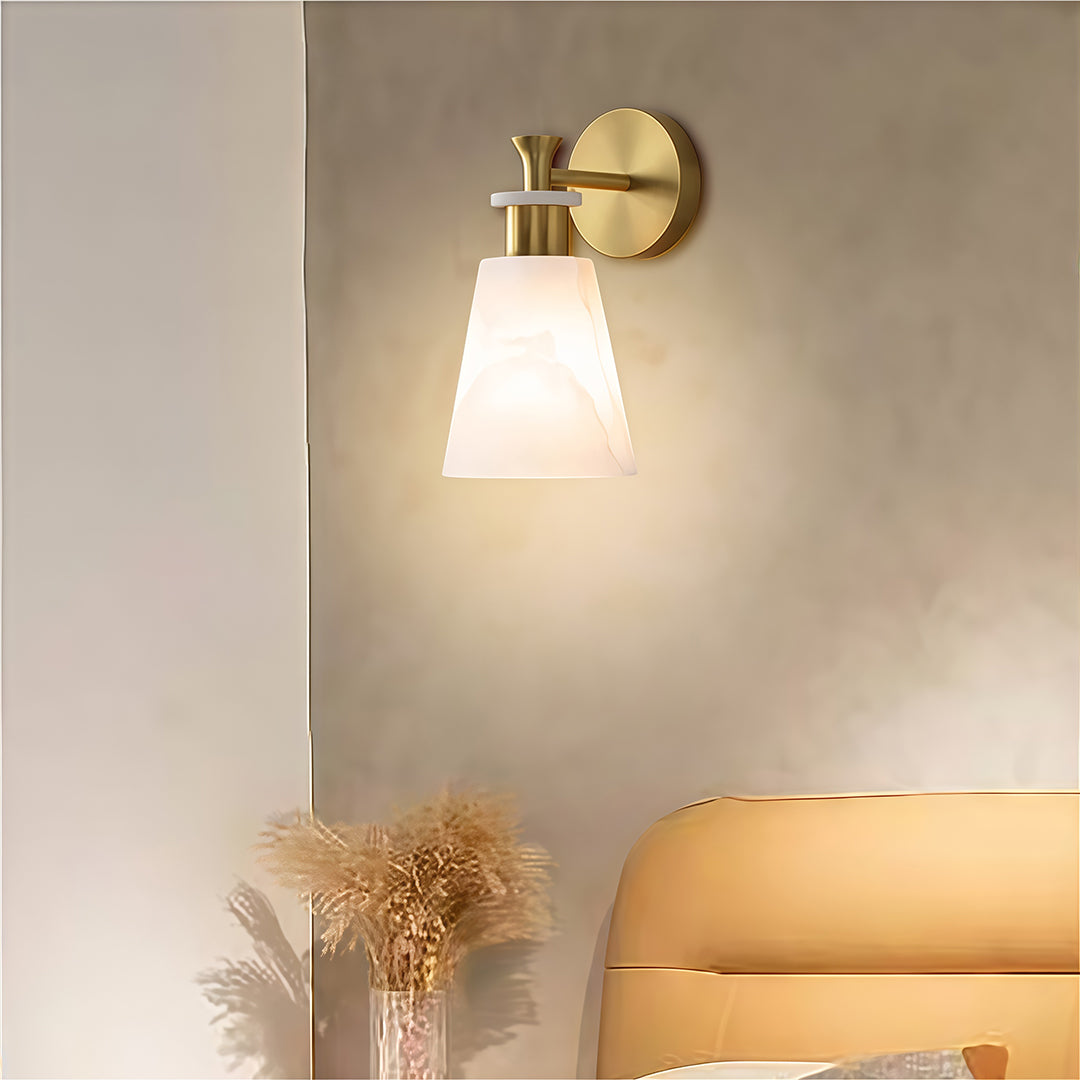 Elegant wall sconce LED light featuring glass shade chandelier design providing ambient lighting beside neutral-toned sofa.