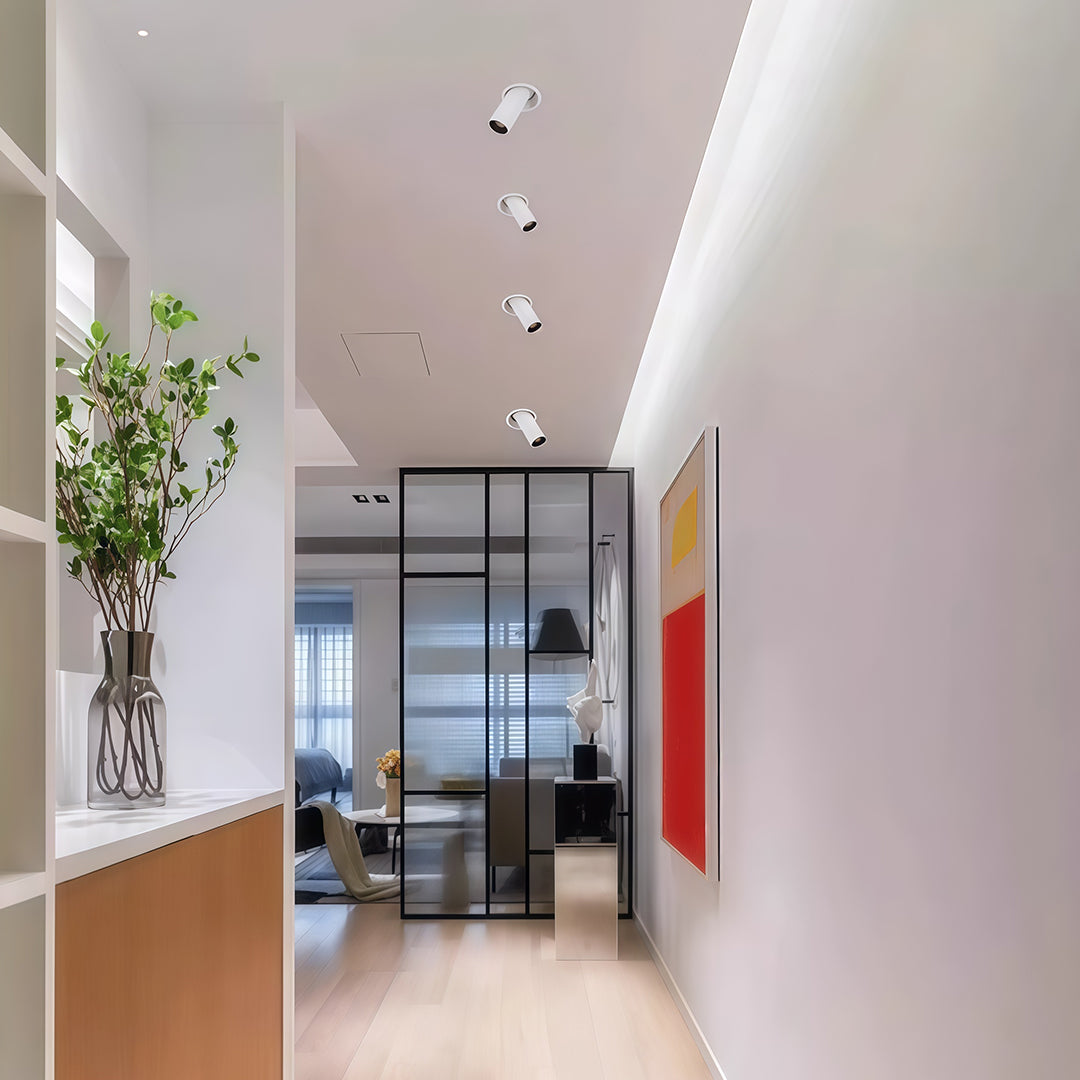 Elegant white adjustable LED ceiling spotlights with glass shade chandelier design highlighting framed artwork in gallery-style room.