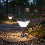 Elegant white conical bollard light creating warm ambiance in residential garden landscape setting