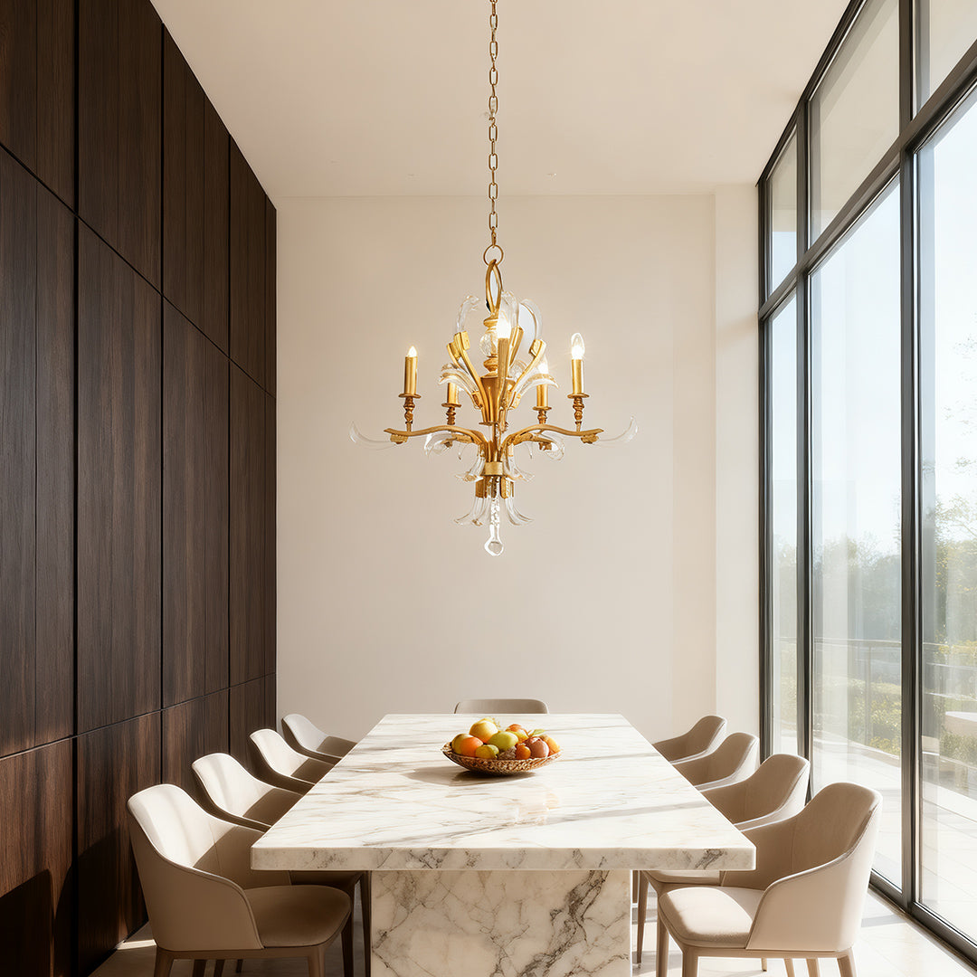 Gold and crystal chandelier providing elegant light above a white curved breakfast nook, positioned perfectly in front of a bay window.