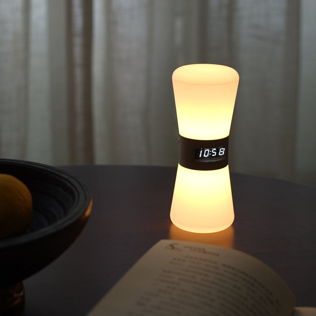 Elegant white hourglass-shaped USB rechargeable table lamp providing warm ambient lighting