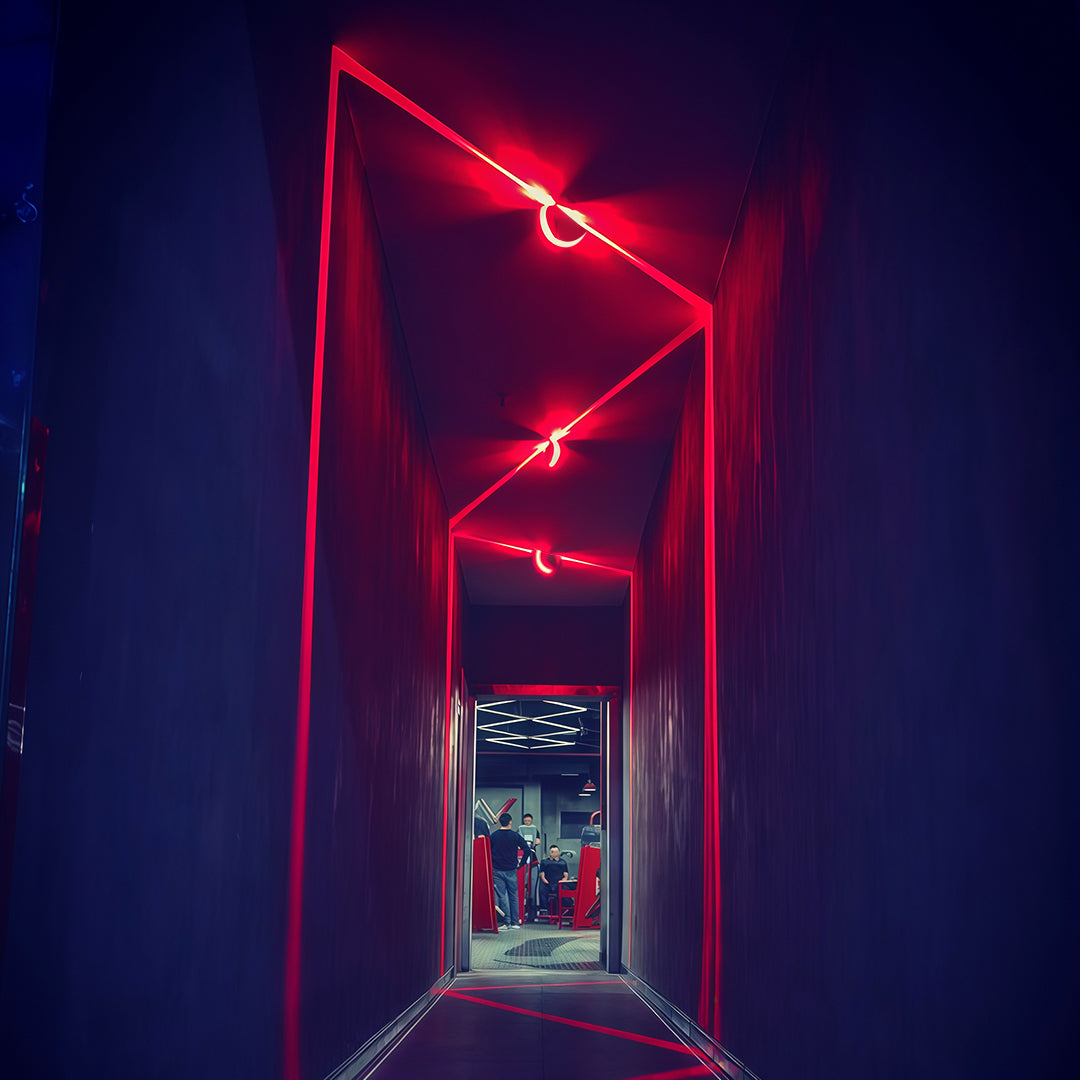 Elegant white outdoor wall lights with glass shade chandelier design creating soft ambient glow on exterior wall.