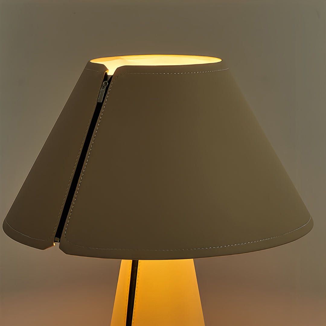 Elegant white table lamp creating warm ambient lighting with golden glow effect