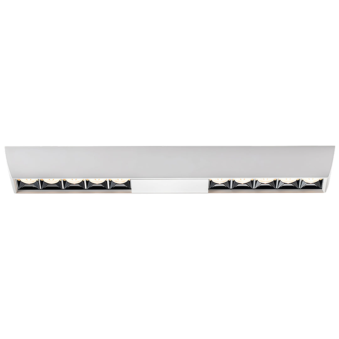 Elongated white surface-mounted fixture containing multiple recessed square downlights modules.