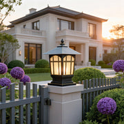 Large outdoor pillar lights installed at a residential gate entrance for ambient lighting.