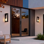 Modern entrance setup featuring warm-toned wall lights flanking the doorway, representing inviting led outdoor wall lighting ideas.