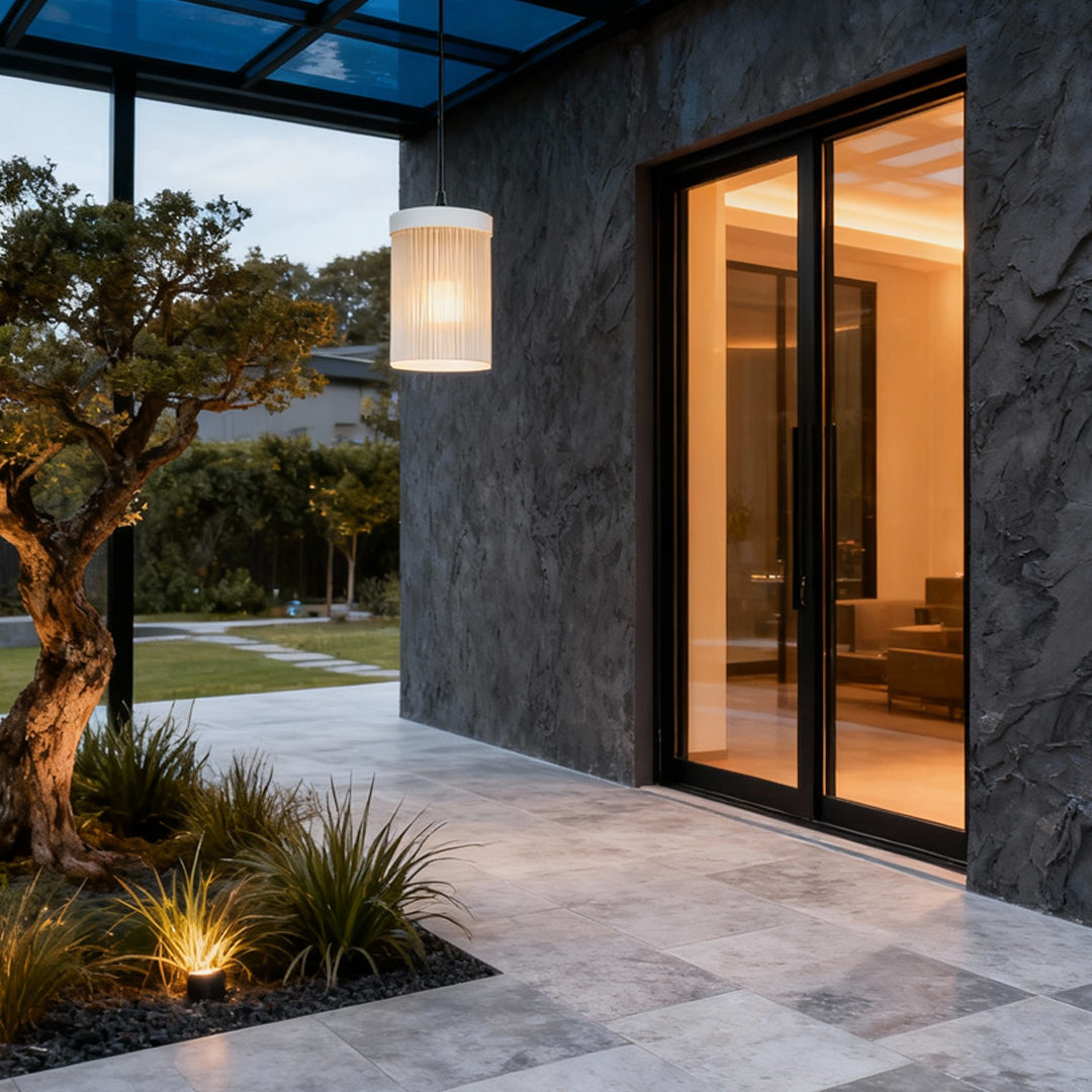 Outdoor pendant light fixture installed beside a modern house entrance providing warm downward illumination.