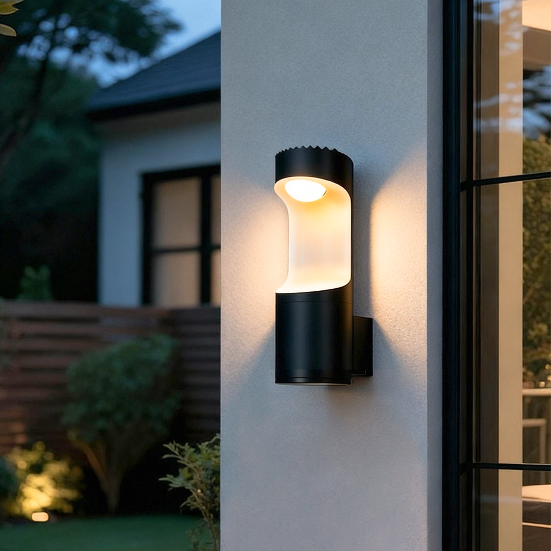 Outdoor wall sconce lighting fixtures installed beside a house entrance, casting warm ambient light.
