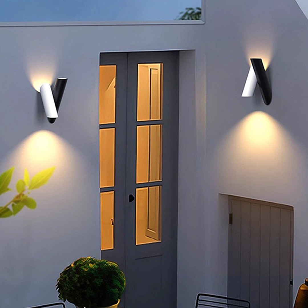 Up and down wall lights outdoor installed near entryway creating warm outdoor ambiance.