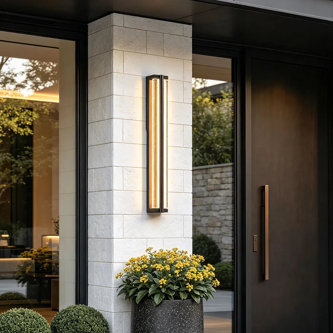 Wall mount outdoor lighting installed beside a front entrance with warm ambient illumination.