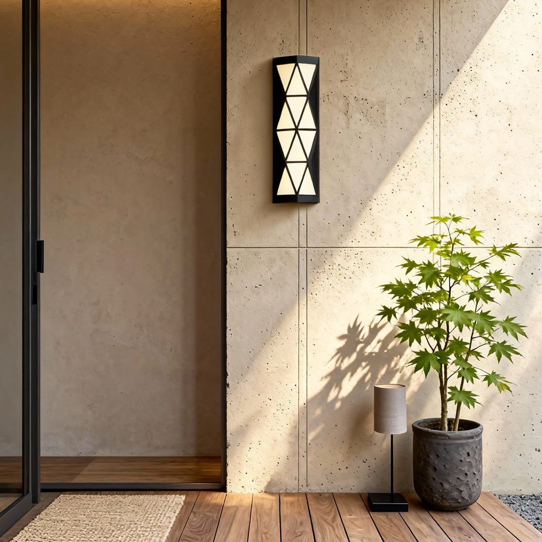 Warm outdoor wall sconces lighting fixture mounted near an entryway, adding welcoming illumination to the space.