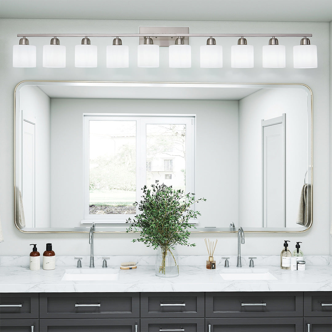 Modern bathroom vanity light with four bulbs, providing even lighting above a double sink vanity.