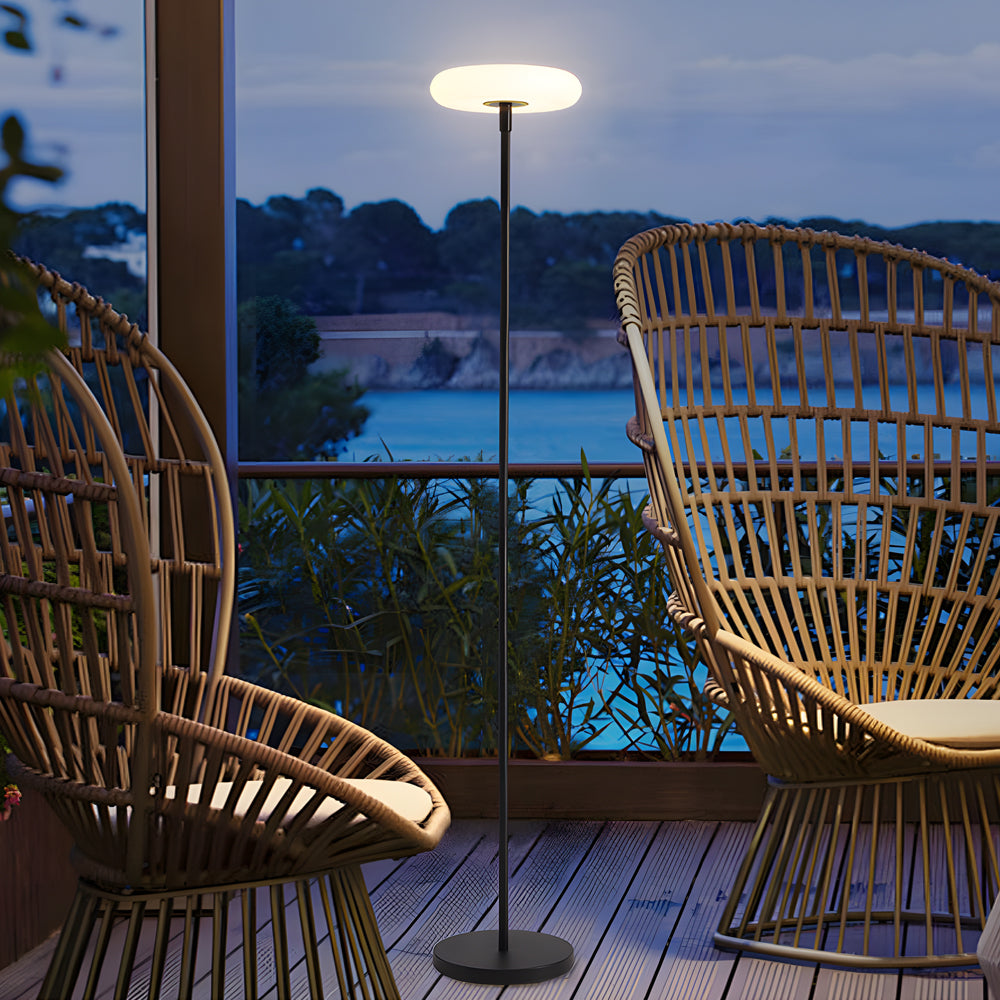 Evening scene featuring halo floor lamp creating atmospheric lighting on modern outdoor deck with contemporary seating