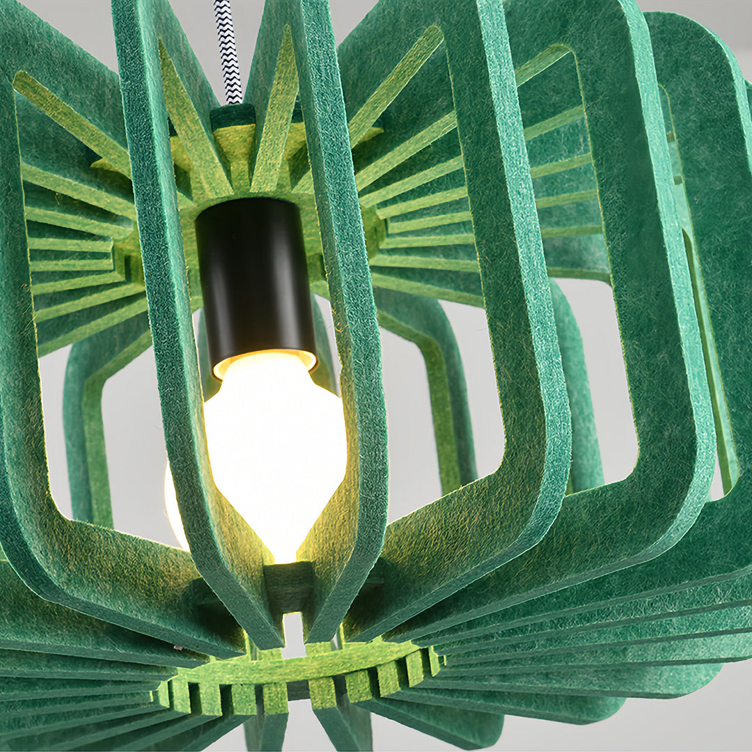 Close-up detail of the exposed bulb and green felt fabric shade of a Nordic pendant light 