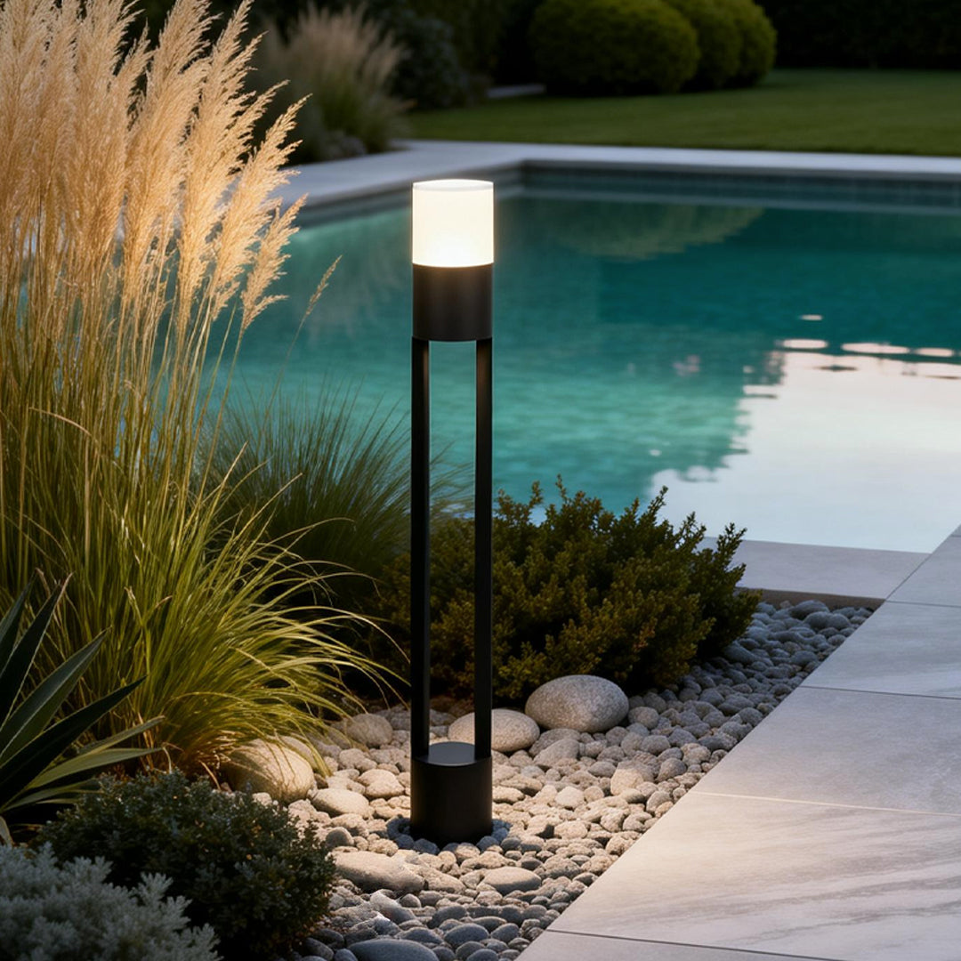 Exterior bollard light fixtures enhancing a contemporary poolside with elegant ambient light.