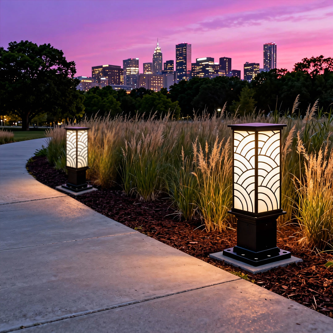 Exterior bollard lights lining a sidewalk at sunset, creating a warm and atmospheric outdoor lighting scene.
