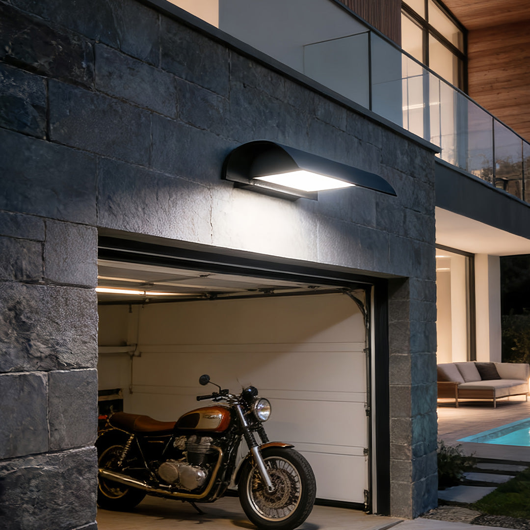 Modern exterior down wall lights installed on outdoor garage wall providing soft downward illumination.