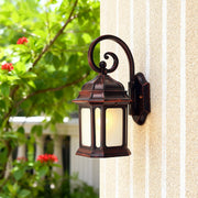 Exterior LED wall light mounted on textured column illuminating bright outdoor patio with garden view