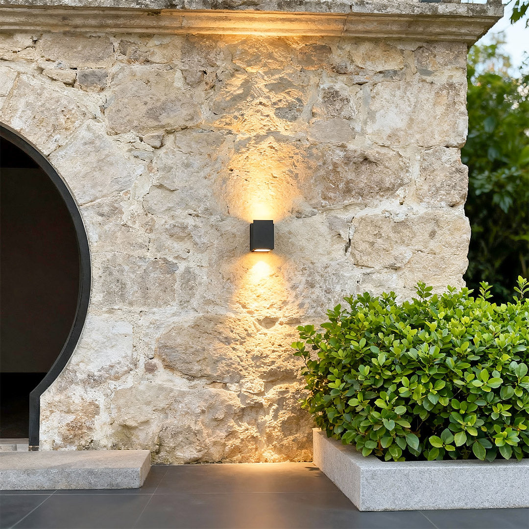 Outdoor wall wash lights mounted beside modern house doorway.
