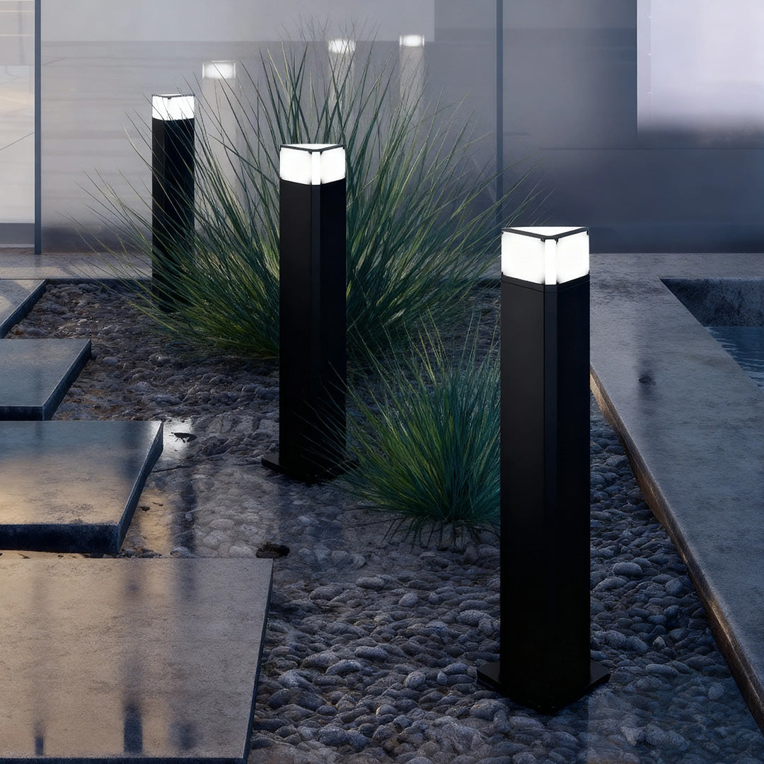 Exterior pathway light placed near a garden patio, enhancing the outdoor ambiance with subtle lighting.