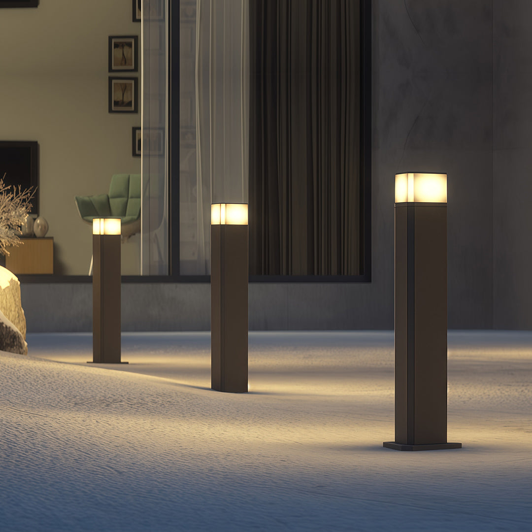 Exterior pathway light near a modern building entrance, providing a welcoming glow.