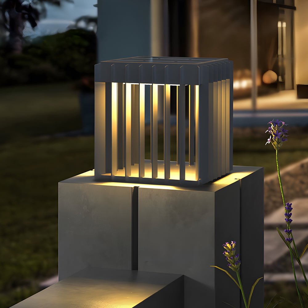 Exterior pillar lights enhancing a contemporary fence with stacked stone pillars.