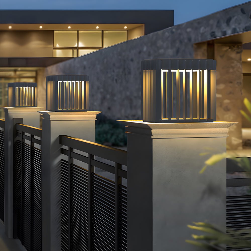 Exterior pillar lights adding elegance to a modern fence with horizontal slats.
